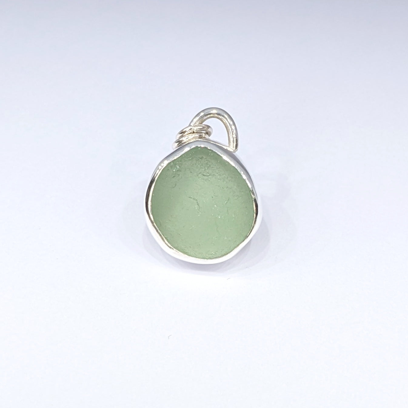 Seafoam sea glass silver pendant with white background