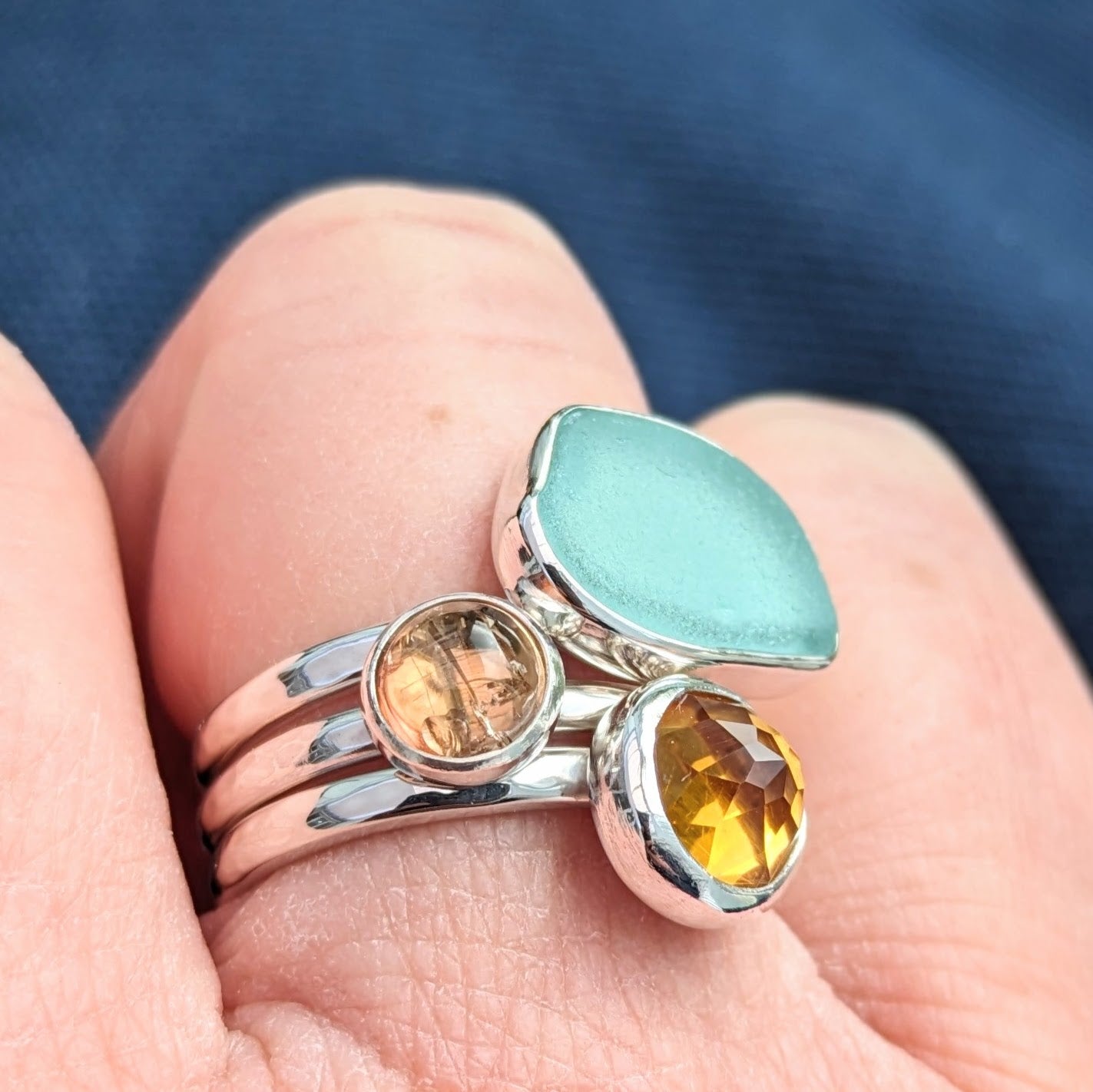 Close up on hand of Cornish Sunset Silver 3 Ring Stack