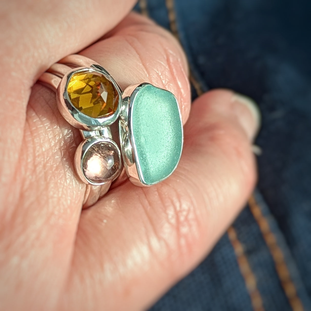 Hand wearing Cornish Sunset 3 Ring Stack