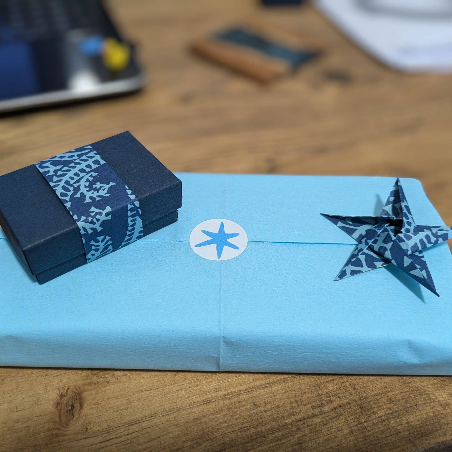 Gift wrapped box, origami star and blue tissue paper wrap for Nicola Prophet Jewellery