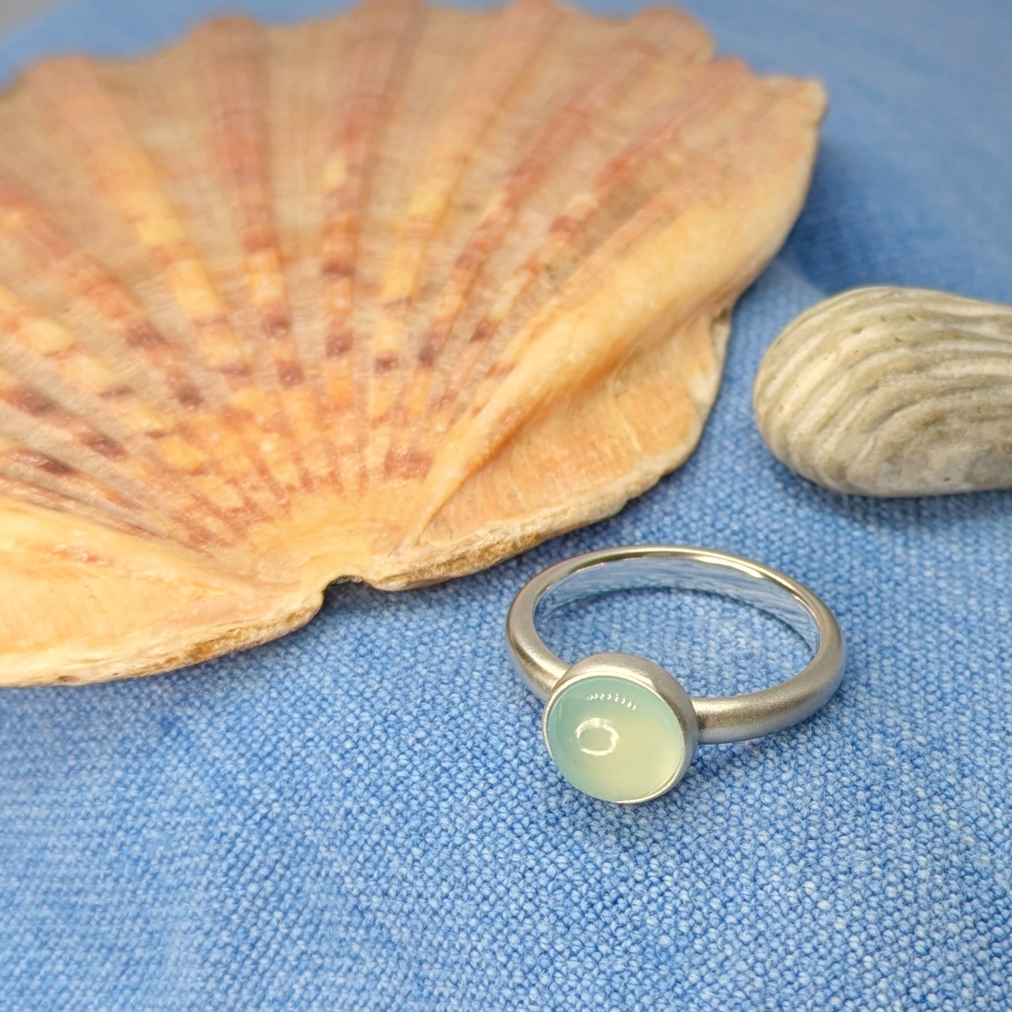 Dreamy Blue Chalcedony Silver Ring next to scallop shell