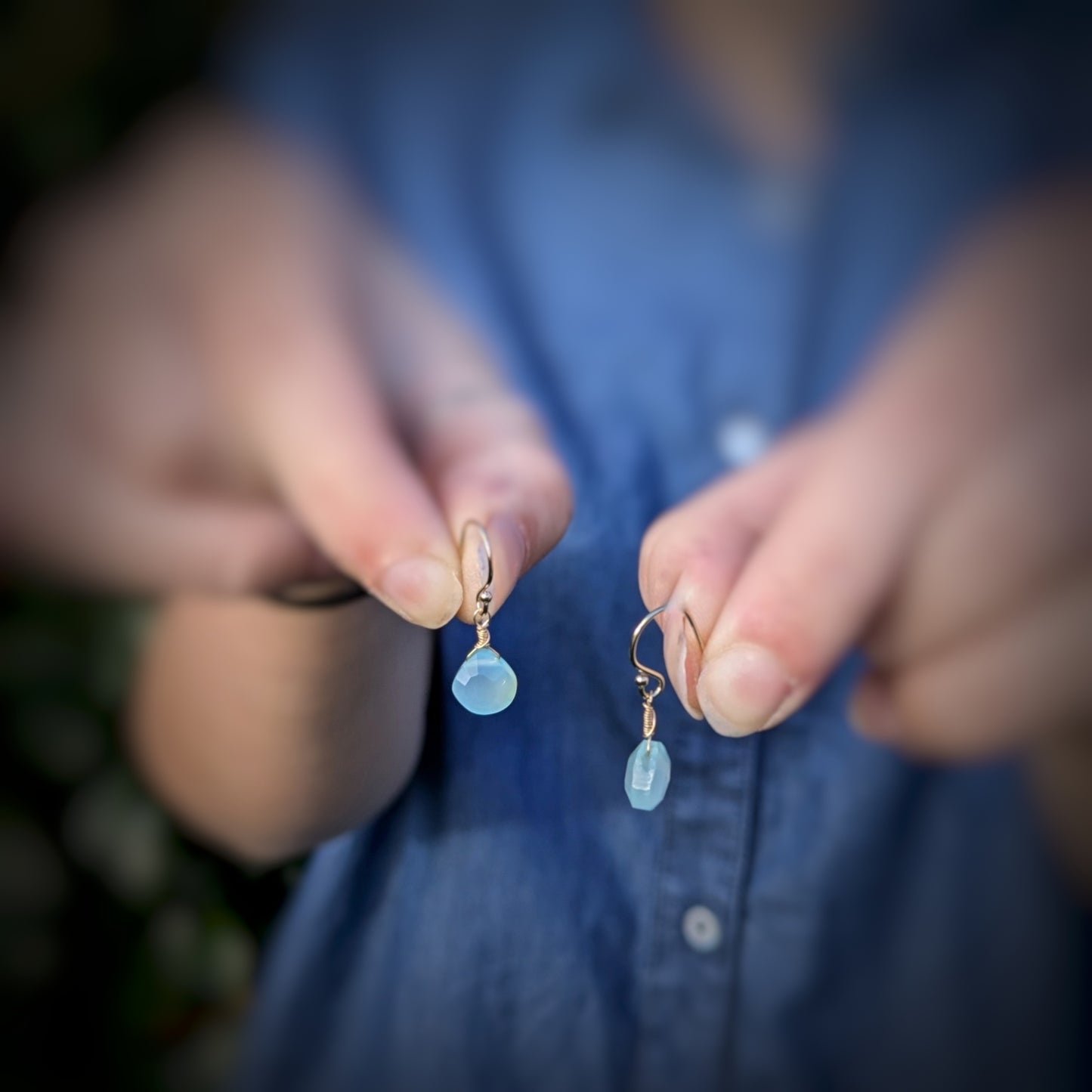 Model holding Dreamy Blue Chalcedony Drop Earrings