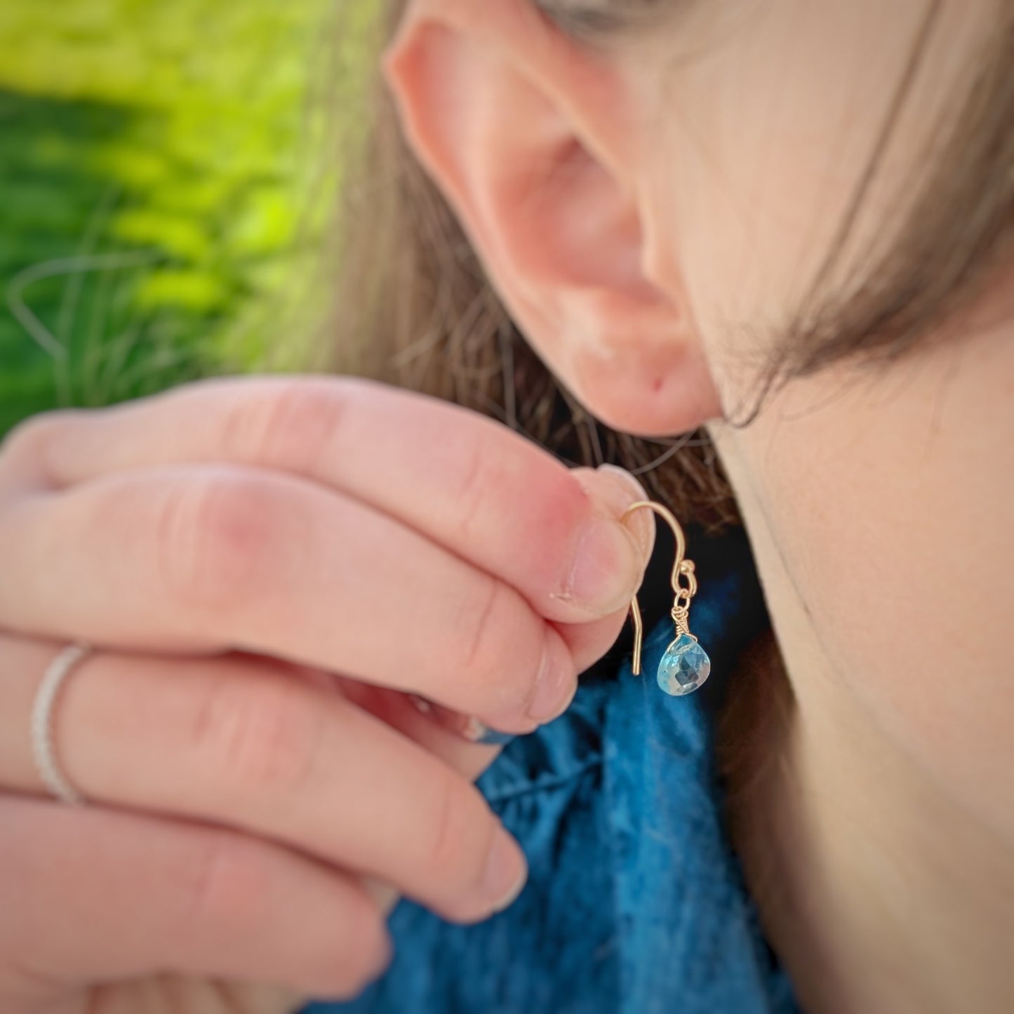 Model holding Ocean Blue Apatite Drop Earring