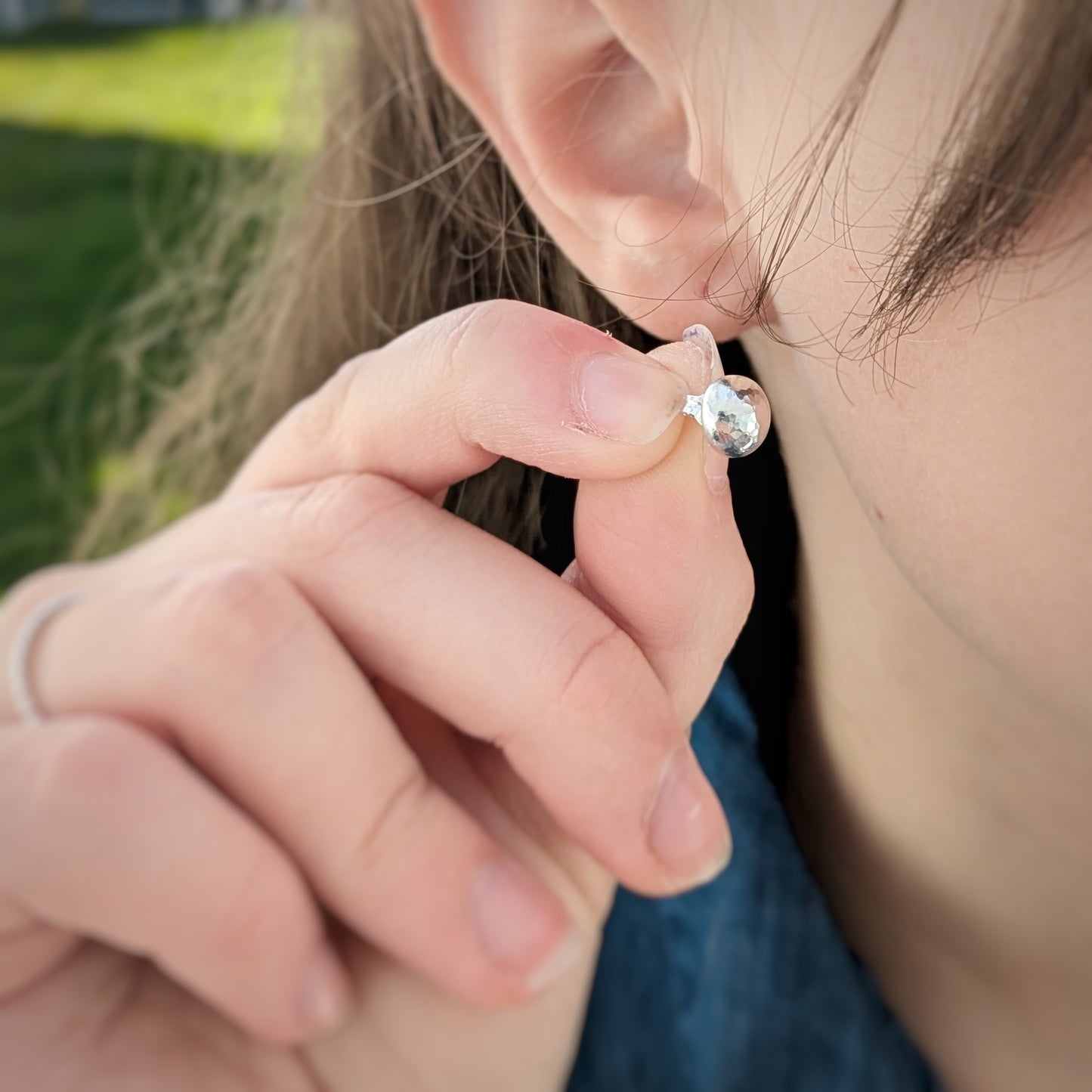 Model holding Rock Pool Pebble Earring