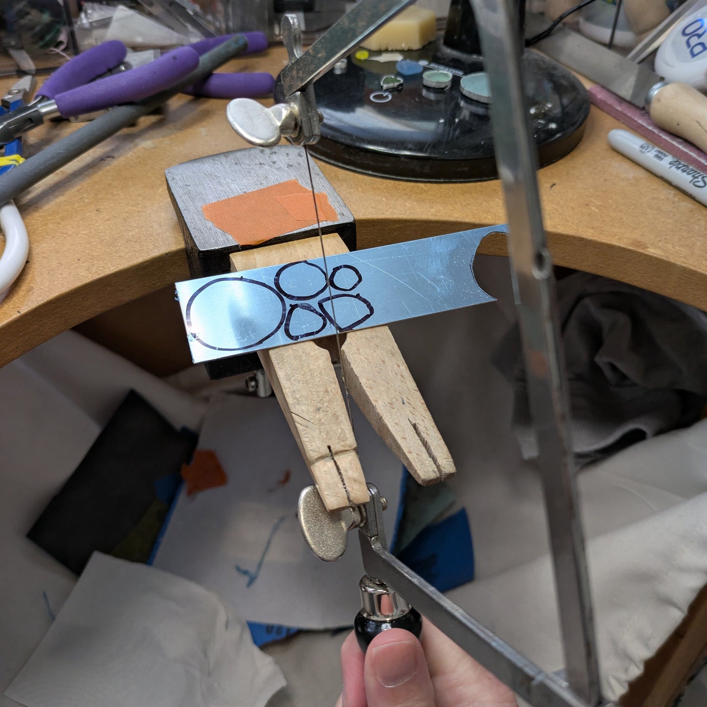 Saw piercing silver at workbench