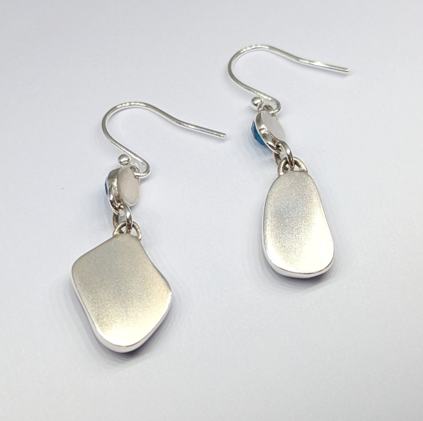 danglyblueseaglassandgemstoneapatitesilverearringsshowingbrushedsilverbacks