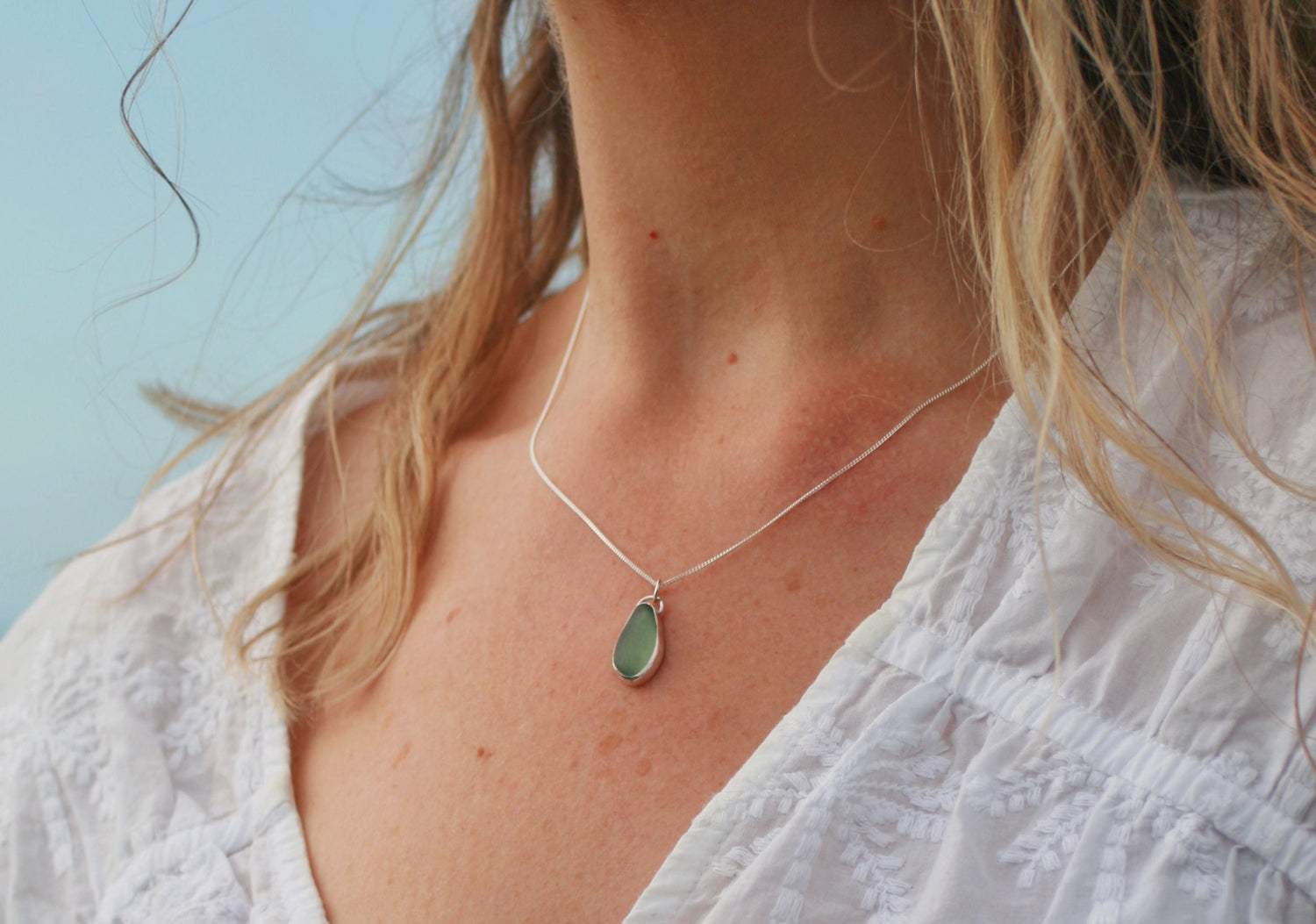 Beautiful sea green, sea glass drop, wrapped in a silver pendant.  Shaped by the waves crashing on the rock; white sea foam, clouds passing by, the ever changing seascape.