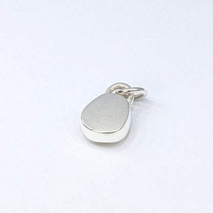 Back view of Rare yellow sea glass silver pendant with white background