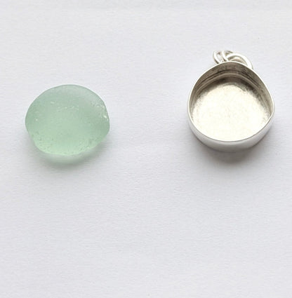 Seafoam sea glass next to silver bezel