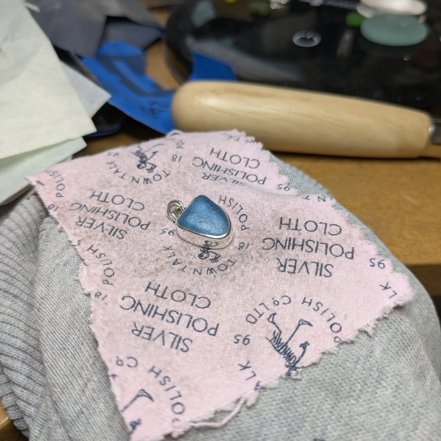 Cornish Blue Sea Glass Silver Pendant on workbench