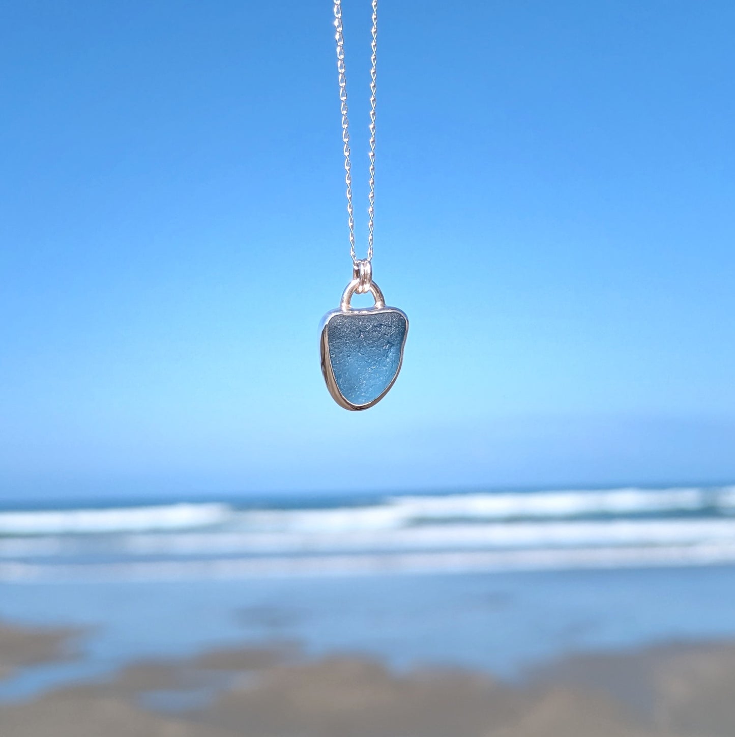 Cornish blue sea glass silver pendant looking out to sea