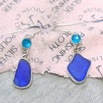 Danglyblueseaglassandgemstoneapatitesilverearringsonpolishingcloth