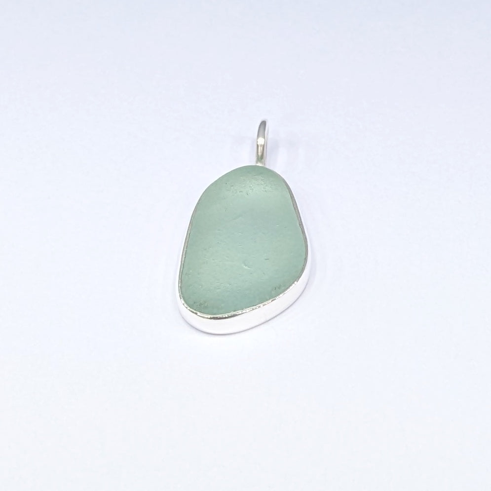 Seafoam sea glass silver pendant with white background