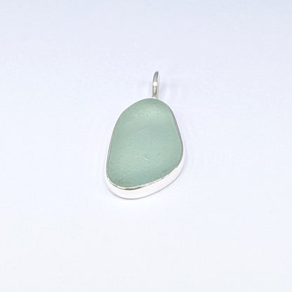 Seafoam sea glass silver pendant with white background