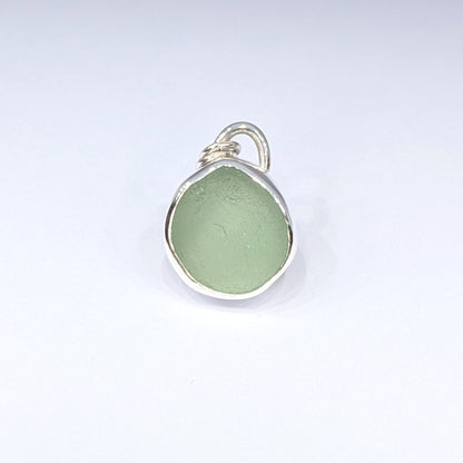 Seafoam sea glass silver pendant with white background