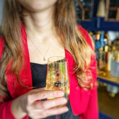 Golden Sparkle Quartz pendant in sterling silver, shown on model with champagne glass