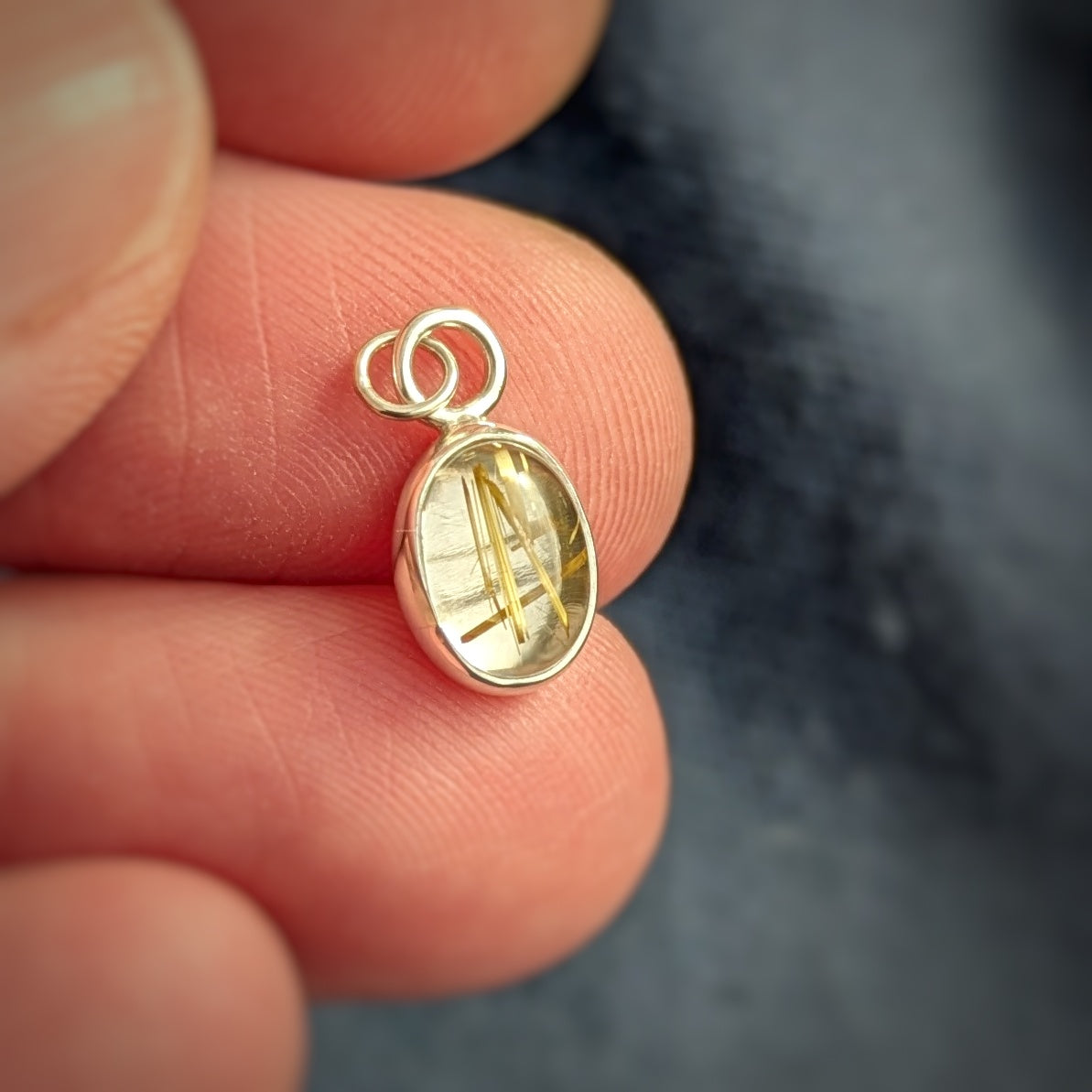 Golden Sparkle Quartz pendant in sterling silver in hand