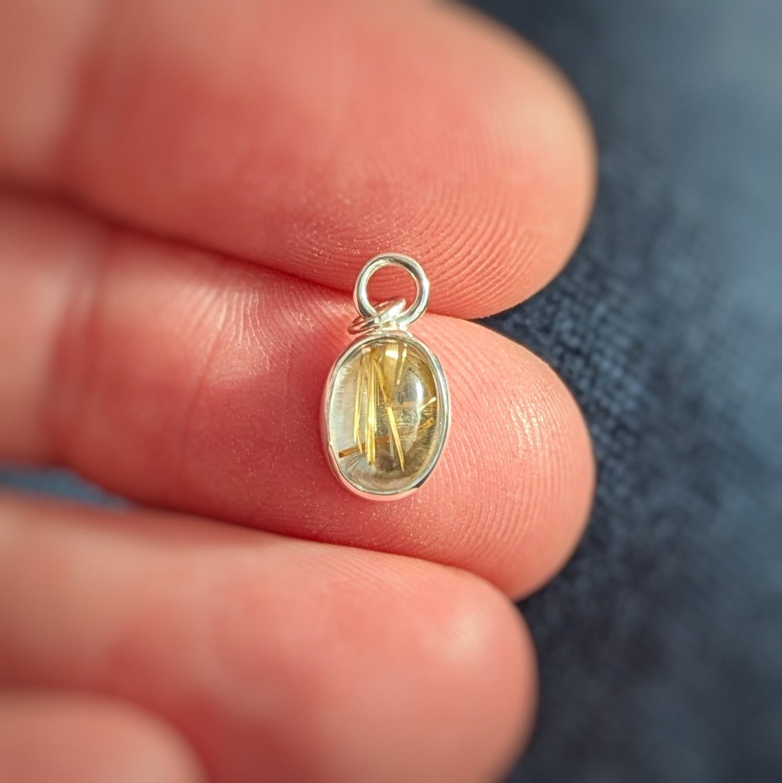 Golden Sparkle Quartz pendant in sterling silver in hand