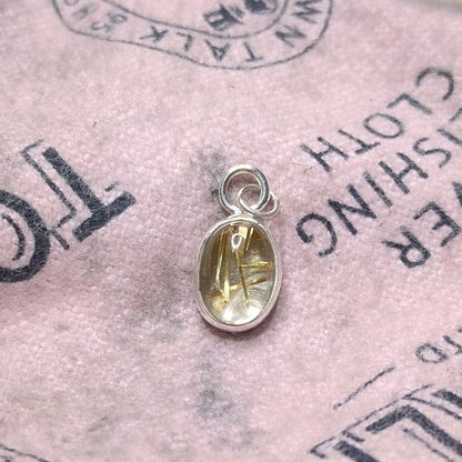 Golden Sparkle Quartz pendant in sterling silver on pink polishing cloth