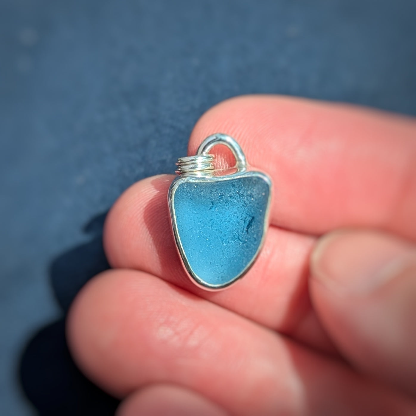 Cornish Blue Sea Glass Silver Pendant in hand