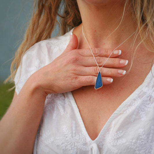 Silver and sea glass drop pendant. Model wearing Midnight Blue Sea Glass Pendant