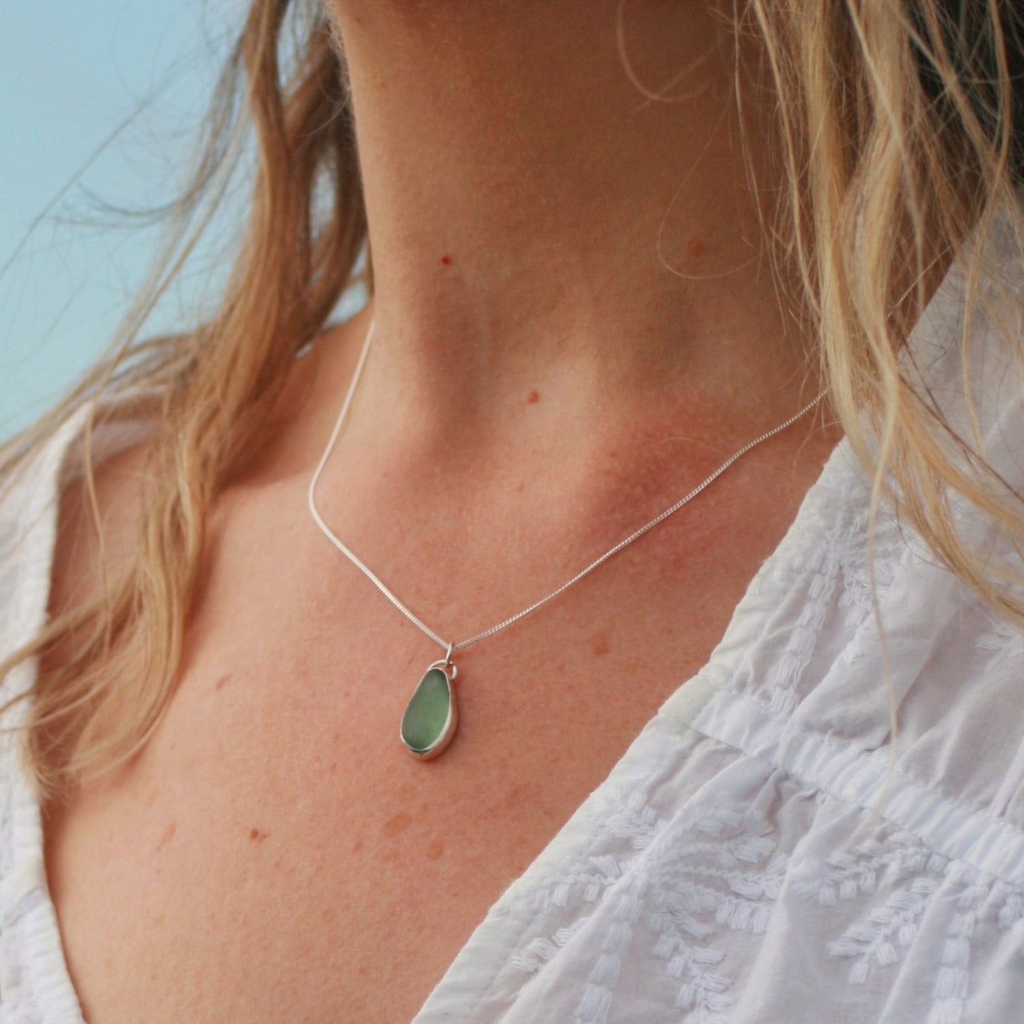 Silver and sea glassModel wearing Sea Green Drop Pendantdrop pendant. 