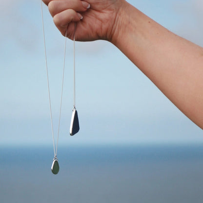 Model holding up Sea Green Drop Pendant