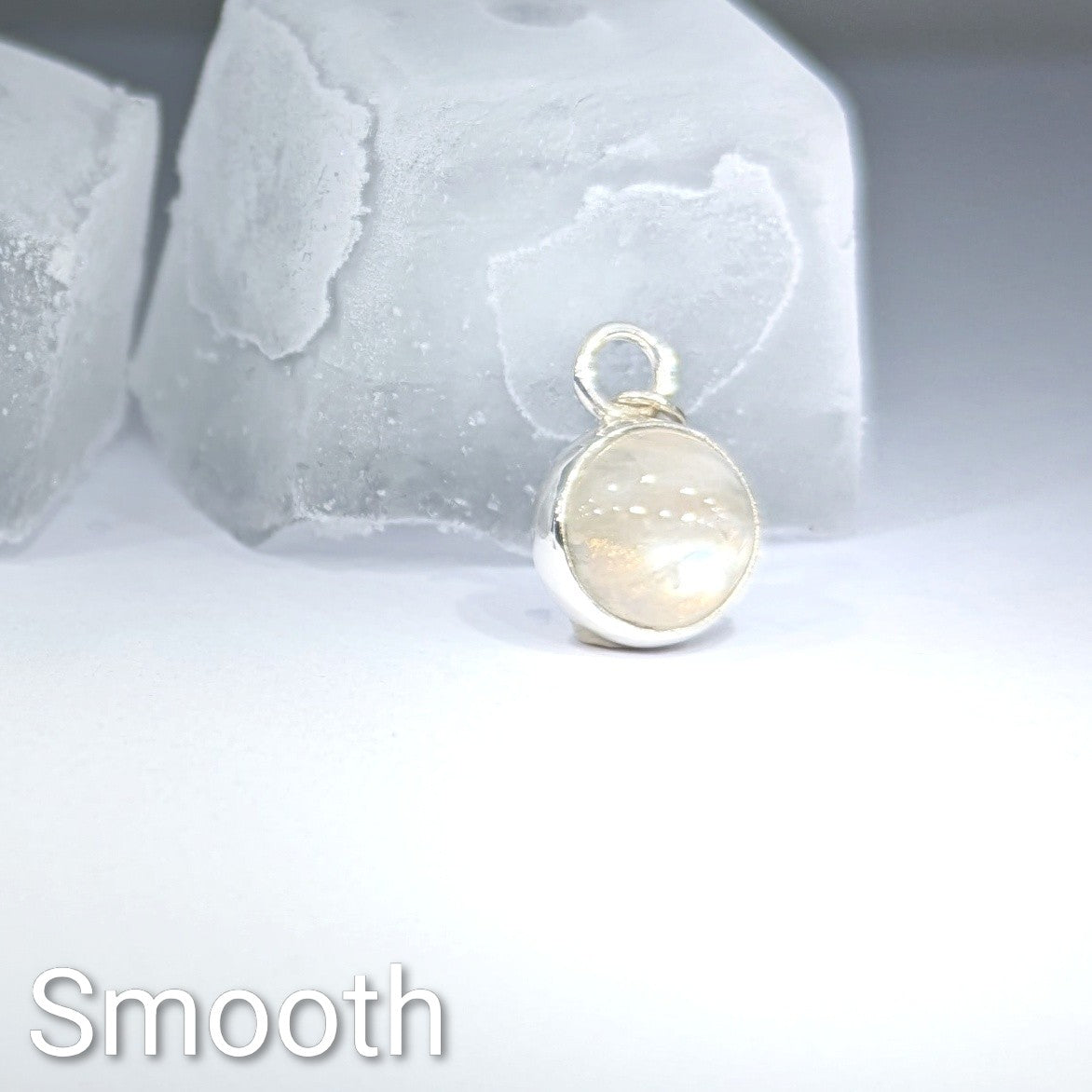 Close up of smooth cut Snowball Moonstone pendant set in sterling silver