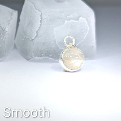Close up of smooth cut Snowball Moonstone pendant set in sterling silver