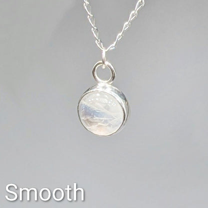 Close up of Smooth cut Snowball Moonstone pendant set in sterling silver on silver chain