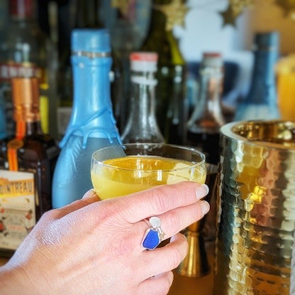 Silver stacker rings with sea glass and gemstones. Model wearing Moonlit Three Ring Stack with cocktail
