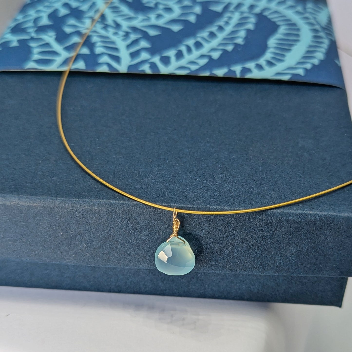 Dreamy Blue Chalcedony Drop Pendant sitting on blue gift box