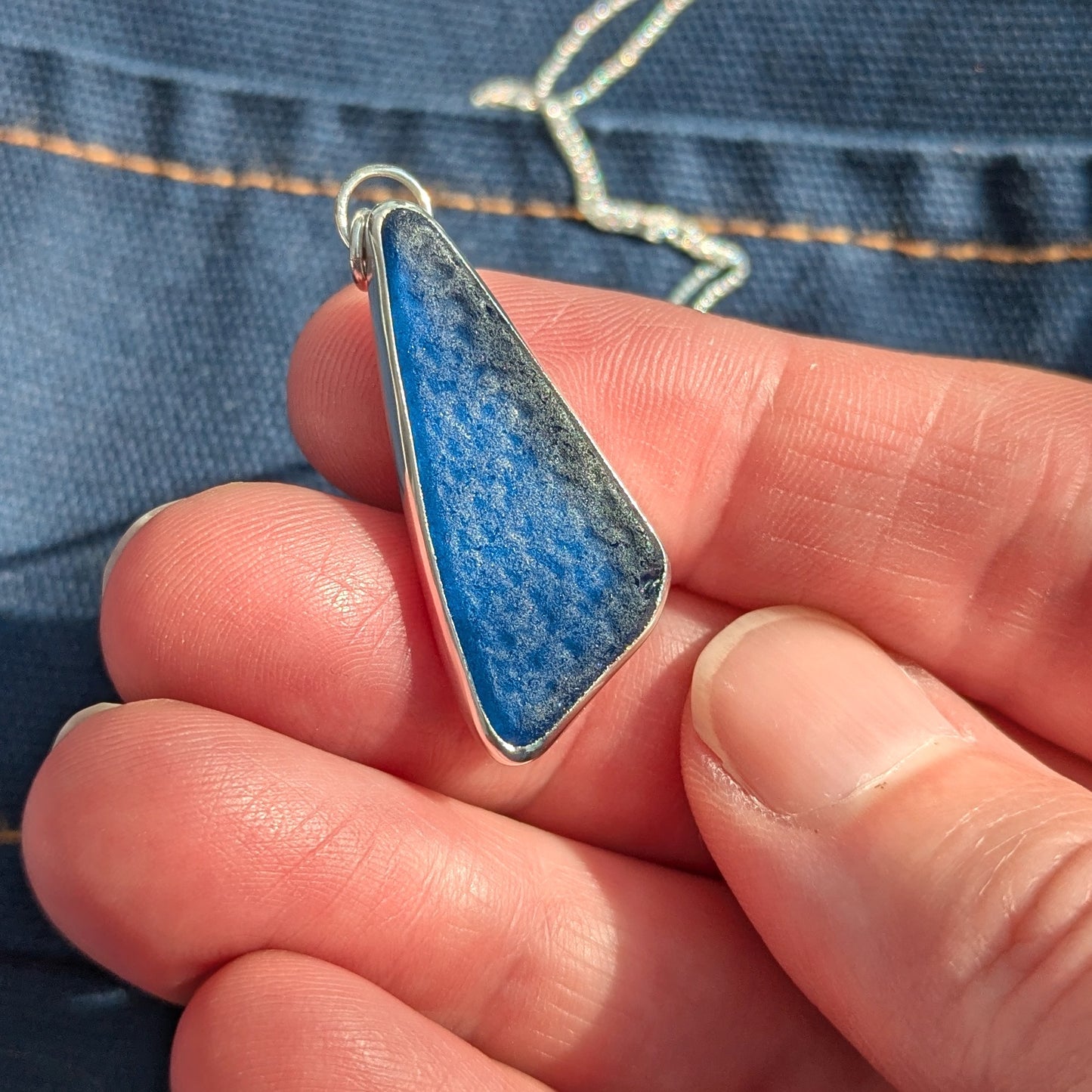 Hand holding Midnight Blue Sea Glass Pendant