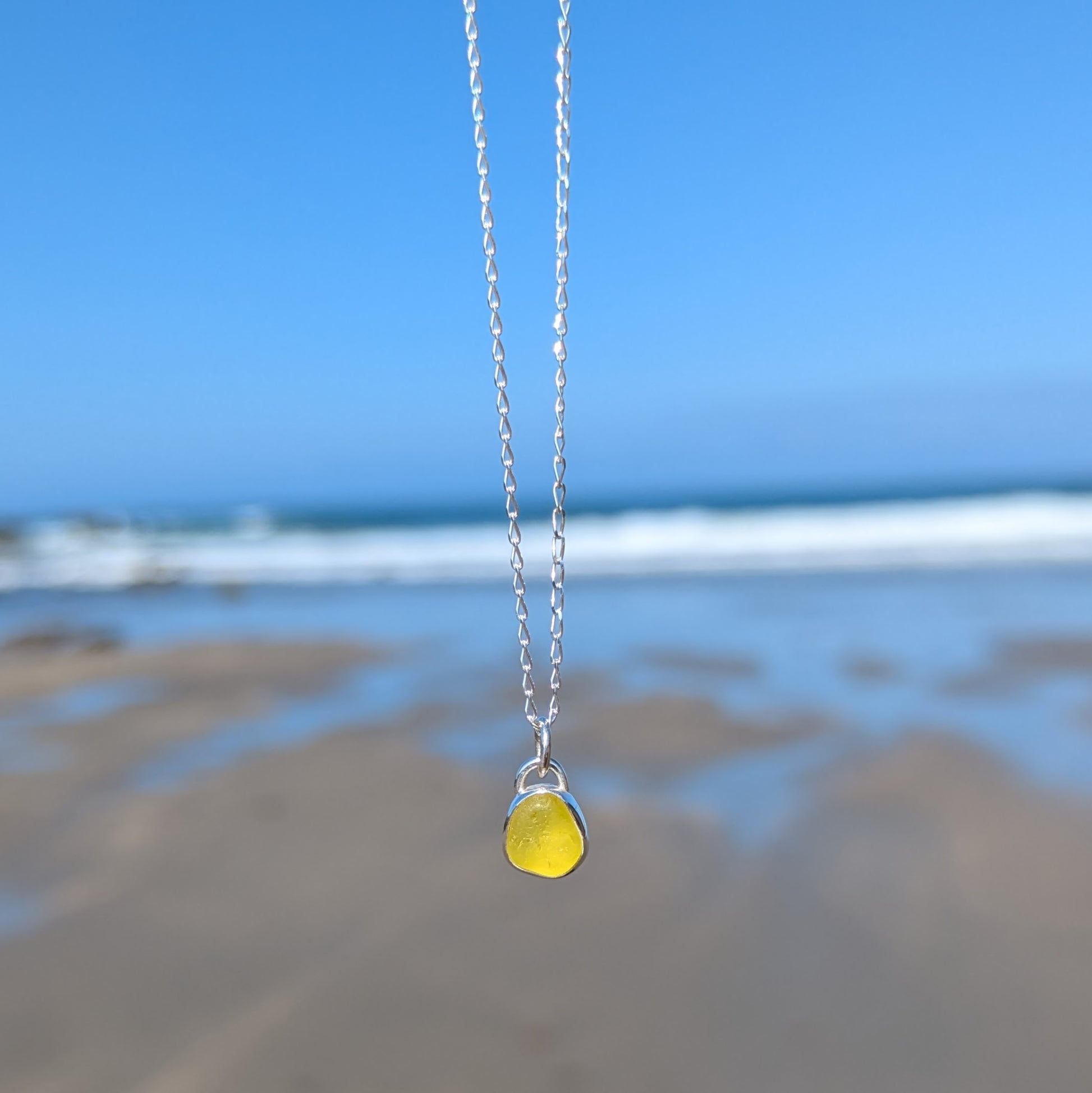 Rare yellow sea glass silver pendant looking out to sea