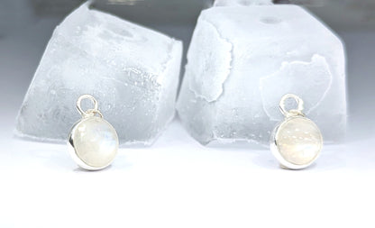 Snowball Moonstone pendant set in sterling silver resting against ice cubes