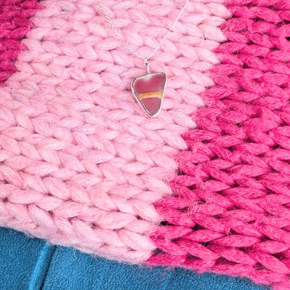 Red Sea Glass Silver Pendant with pink stripey cardi and blue background