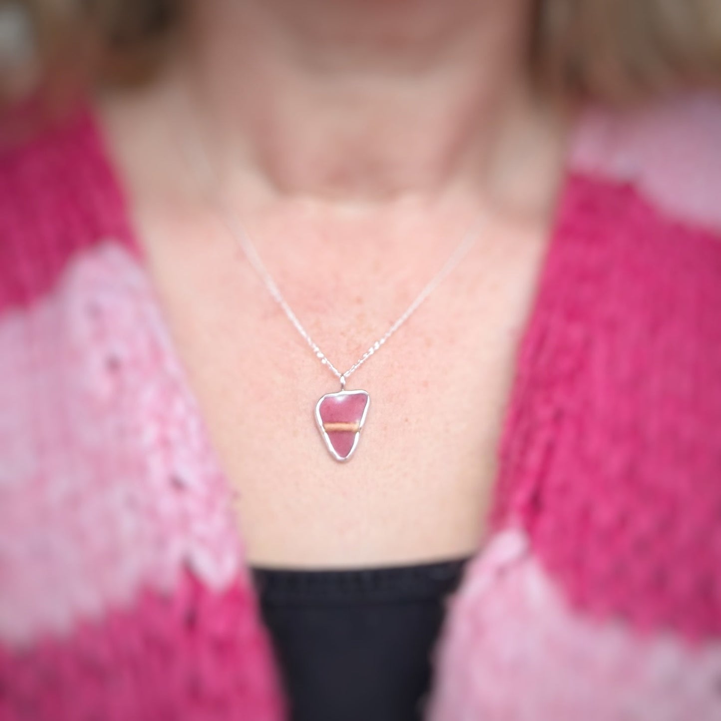 Red Sea Glass silver pendant worn by model in a pink stripey cardi