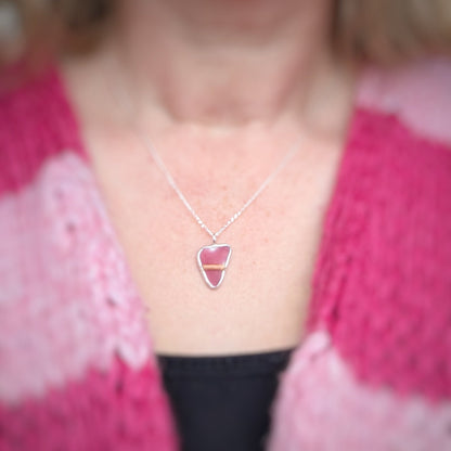Red Sea Glass silver pendant worn by model in a pink stripey cardi