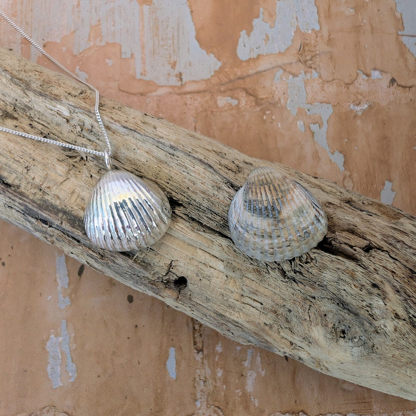 Silver Sea Shell Pendant on driftwood next to original sea shell