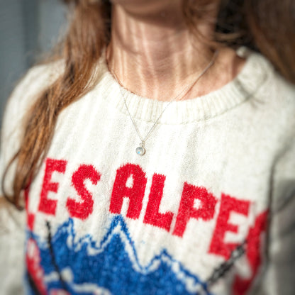 Winter jumper model wearing Snowball Moonstone pendant set in sterling silver