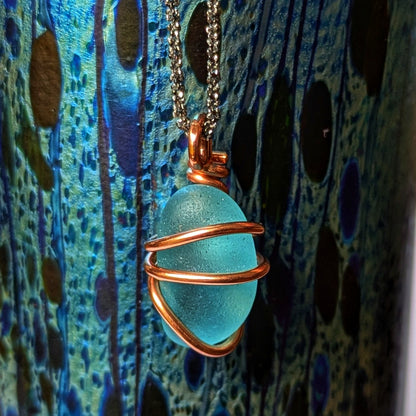 Rare turquoise sea glass wrapped in copper pendant, with a dramatic art deco style glass vase