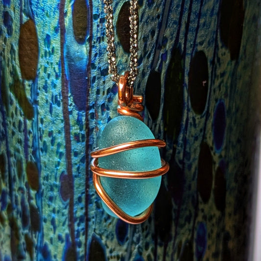 Rare turquoise sea glass wrapped in copper pendant, with a dramatic art deco style glass vase