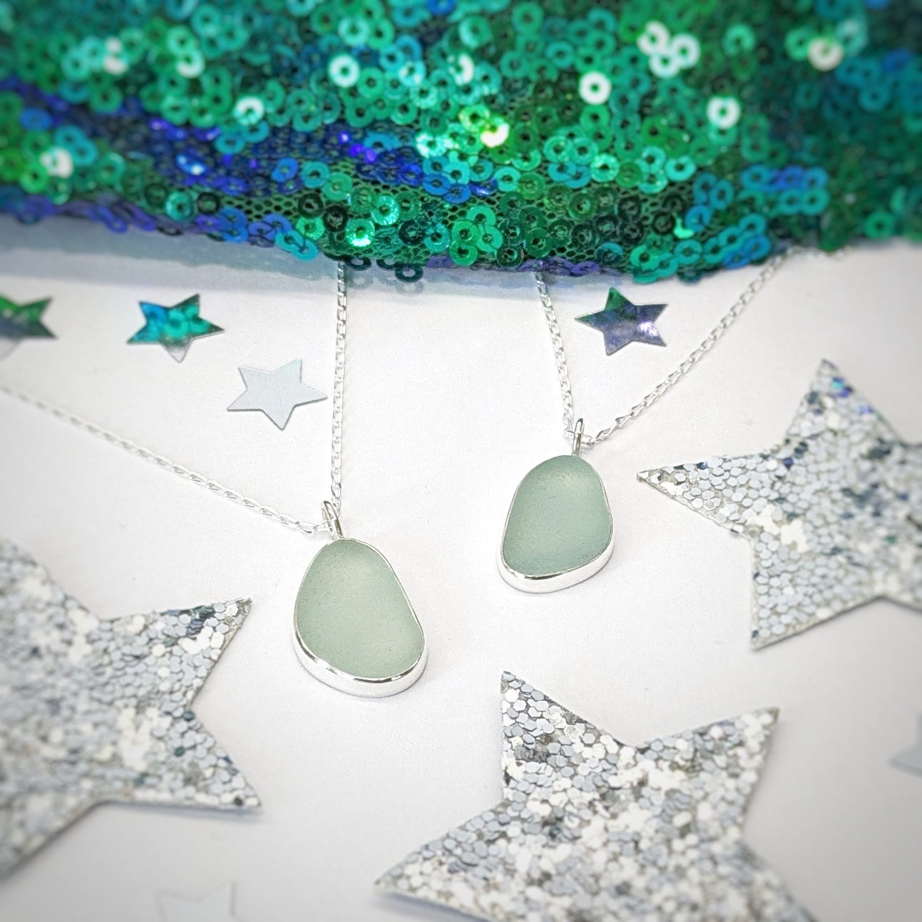Sea glass pendant in sea foam green set in sterling silver with festive decorations