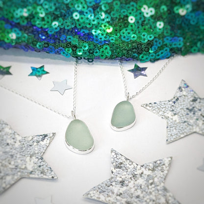 Sea glass pendant in sea foam green set in sterling silver with festive decorations