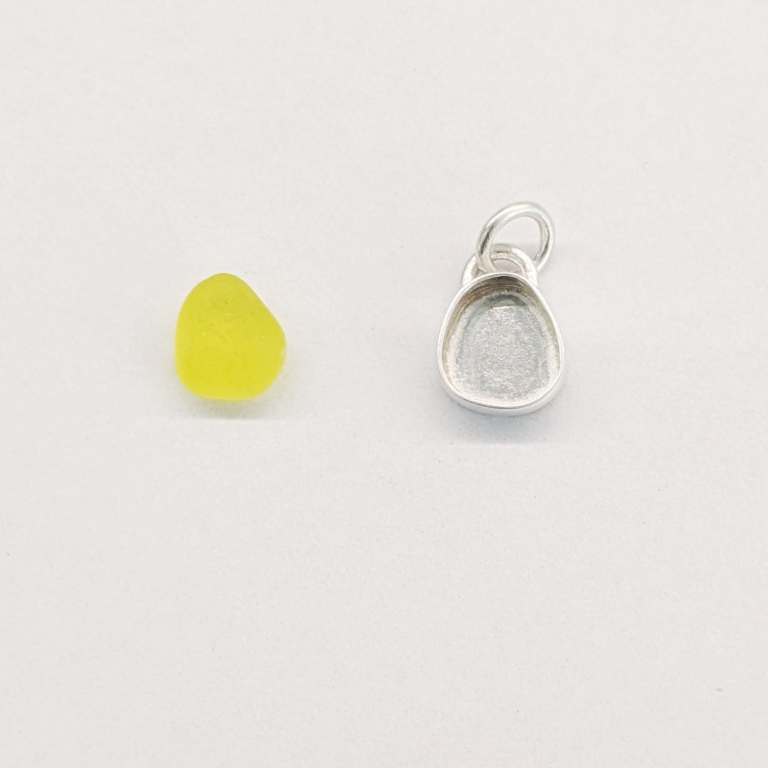 Yellow sea glass ready to set into silver bezel