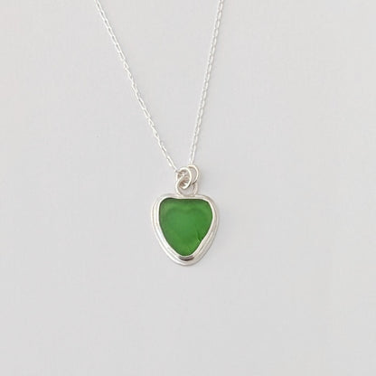 Front view of Green Sea Glass silver pendant with heart shape cut out, with silver chain 