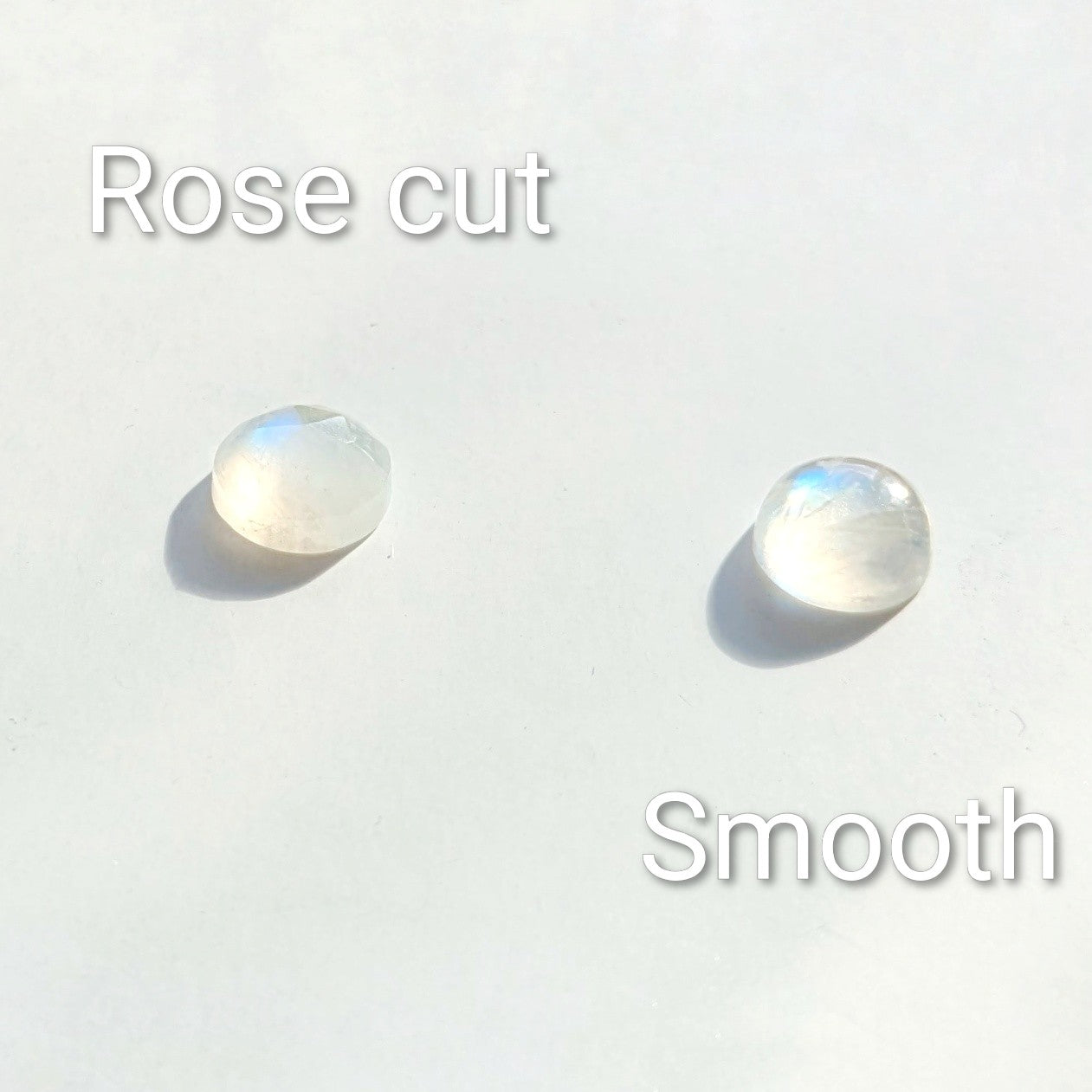 Close up of Snowball Moonstone pendant set in sterling silver - one is a Rose cut gem the other a smooth gem