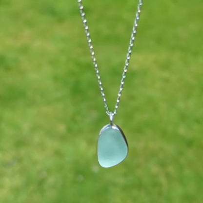 video of Seafoam sea glass silver pendant outside