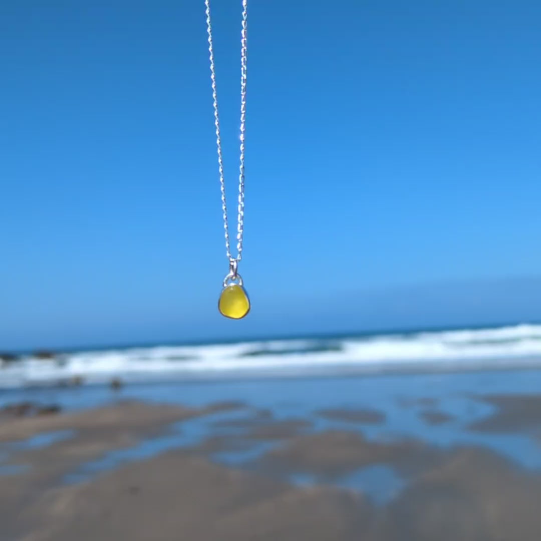 Video of rare yellow sea glass silver pendant looking out to sea