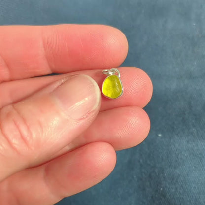 Video of hand showing Rare yellow sea glass silver pendant